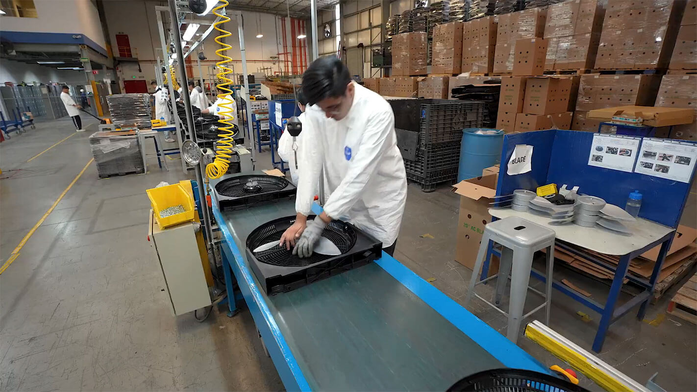 Operator assembling a unit on a production line inside a Shelmex facility