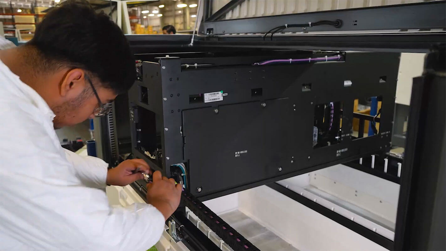 Technician assembling an electronic equipment cabinet at Shelmex in Mexico