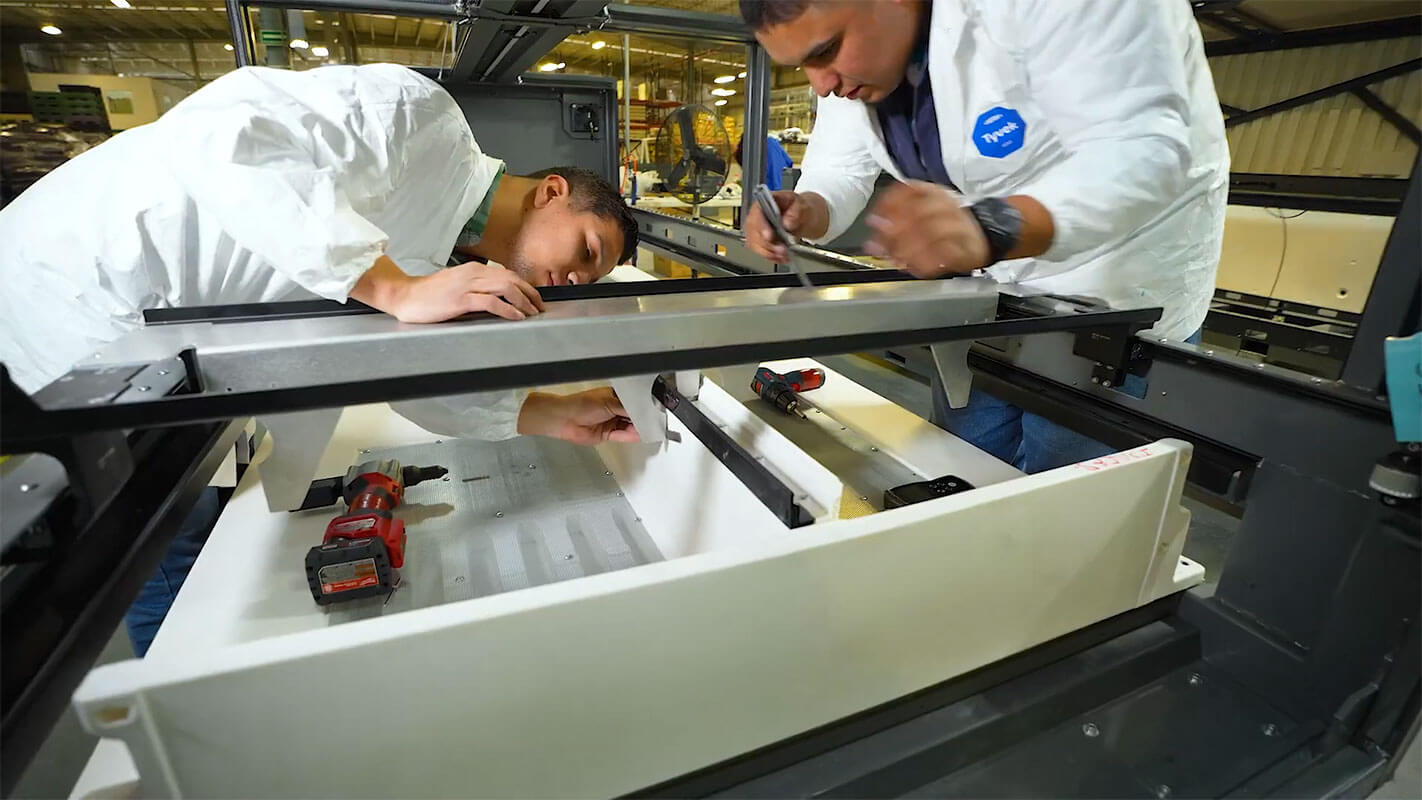 Technicians installing electronic components in a product housing at Shelmex