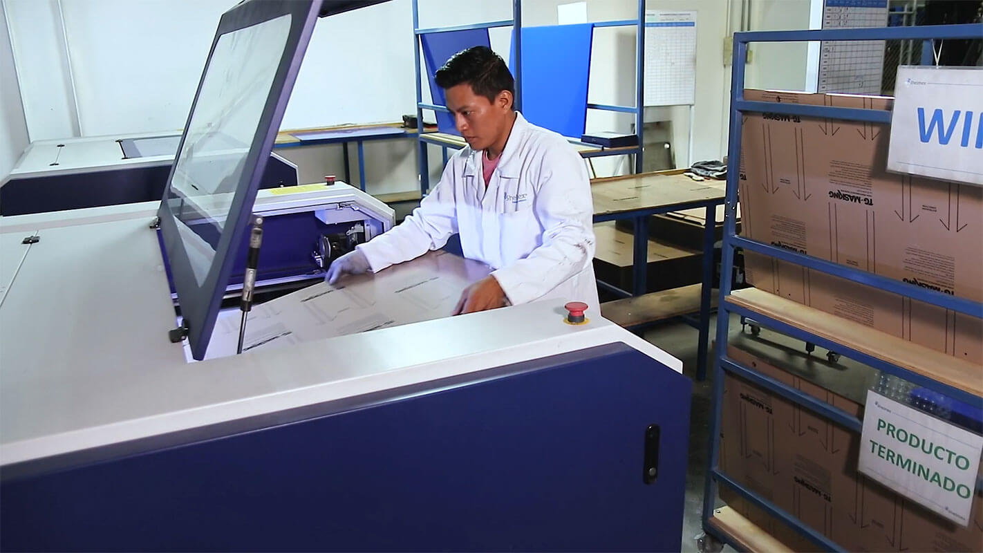 Technician working at a machine inside a Shelmex plant in Mexico